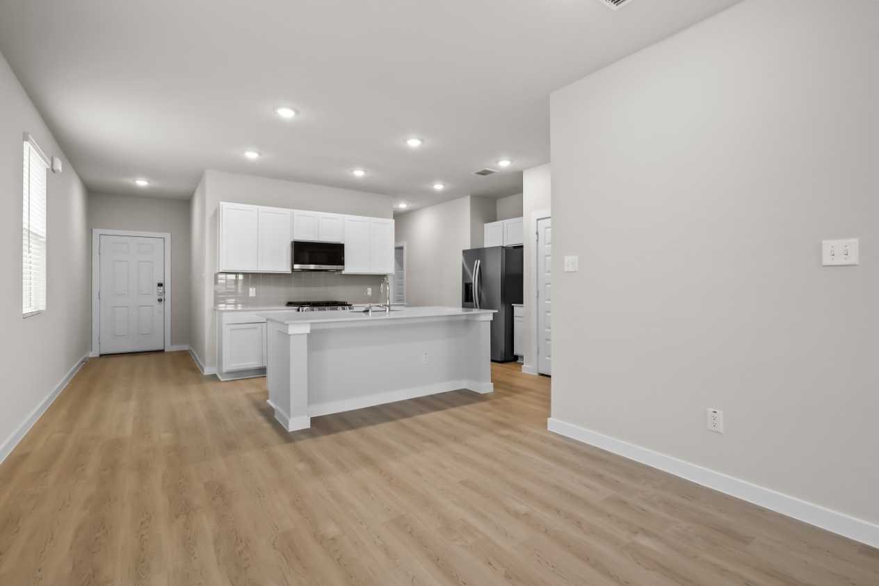 A kitchen with white cabinets.