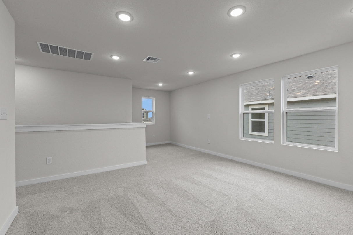 A room with white walls and windows.