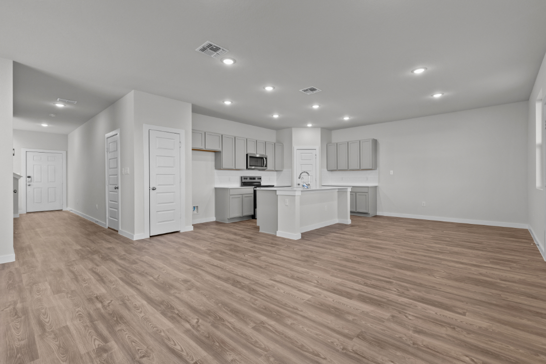 A large kitchen with white cabinets.