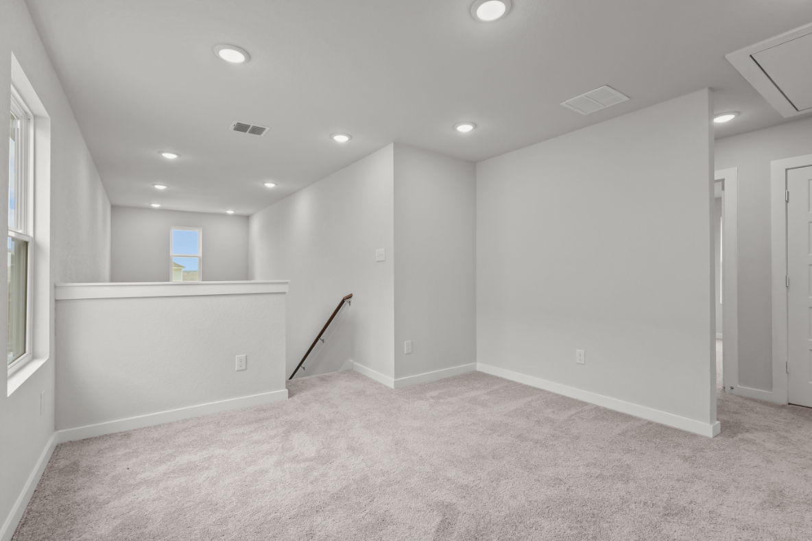 A room with white walls and a broom in it.