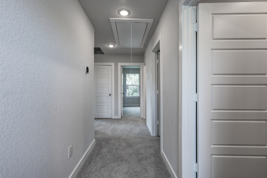 A hallway with white walls.