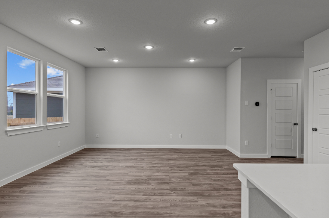A room with white walls and a wood floor.