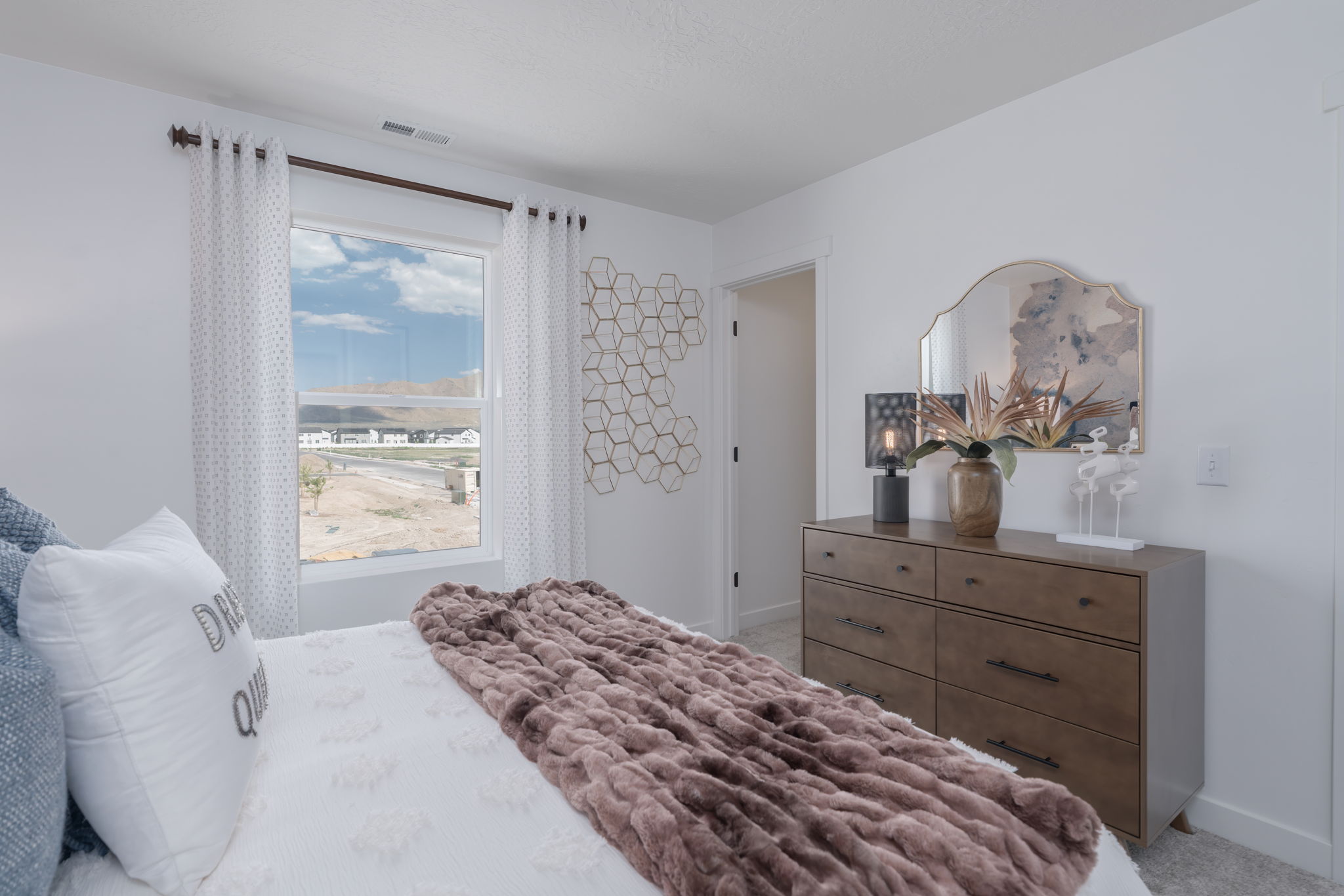 A bedroom with a large window.