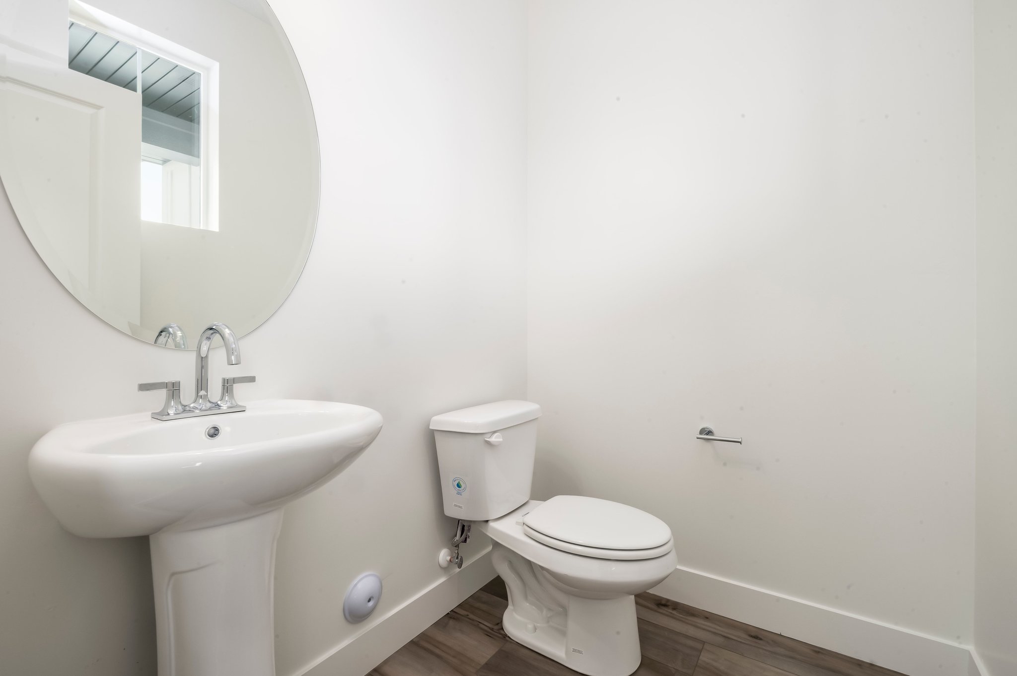 A bathroom with a toilet and sink.