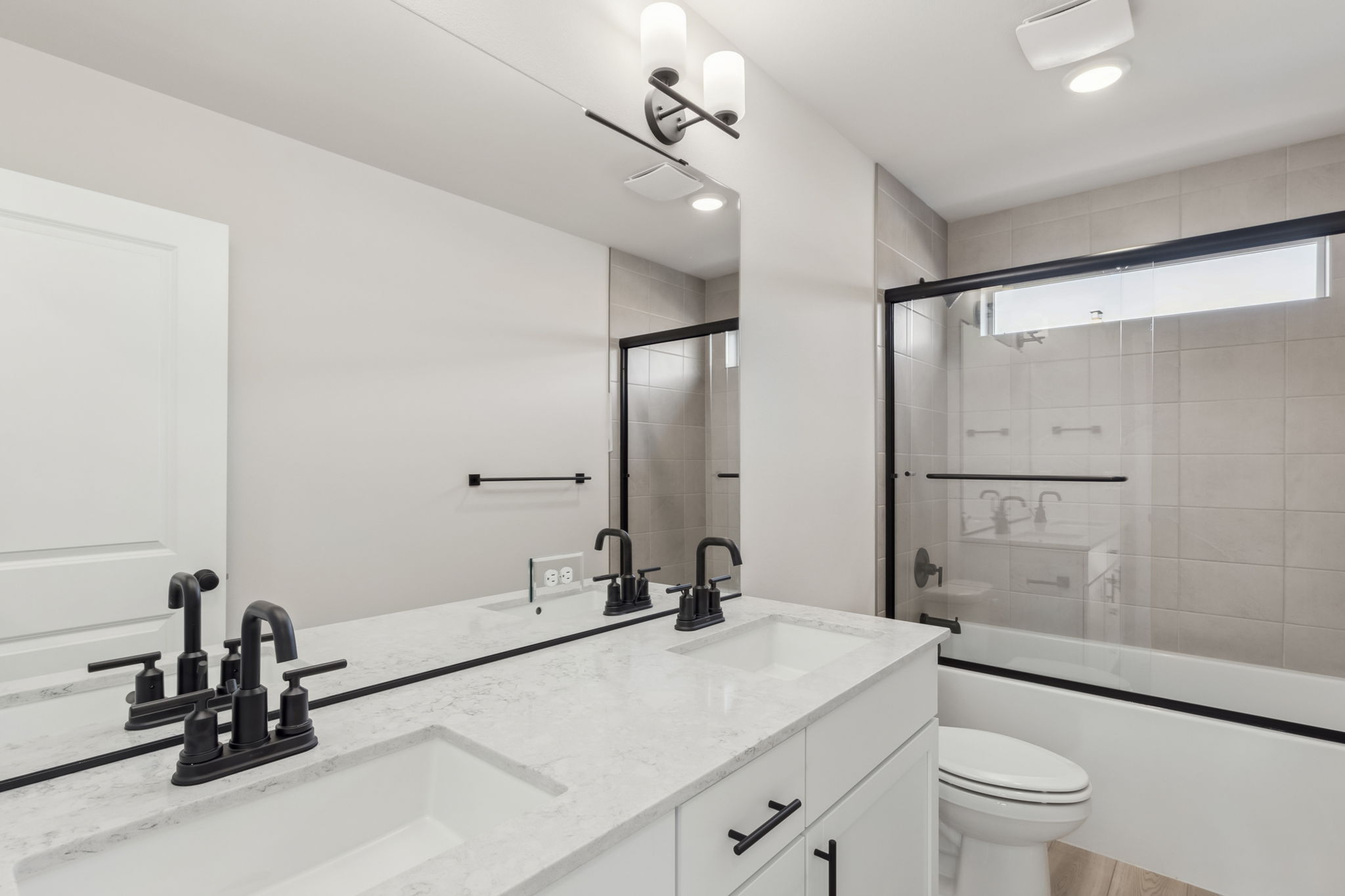 A bathroom with a tub sink and toilet.