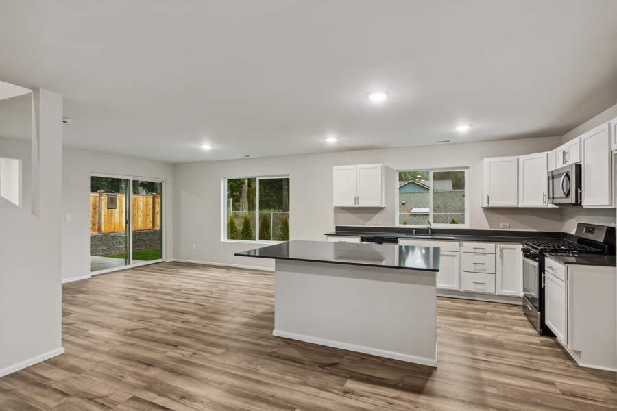 A kitchen with white cabinets.