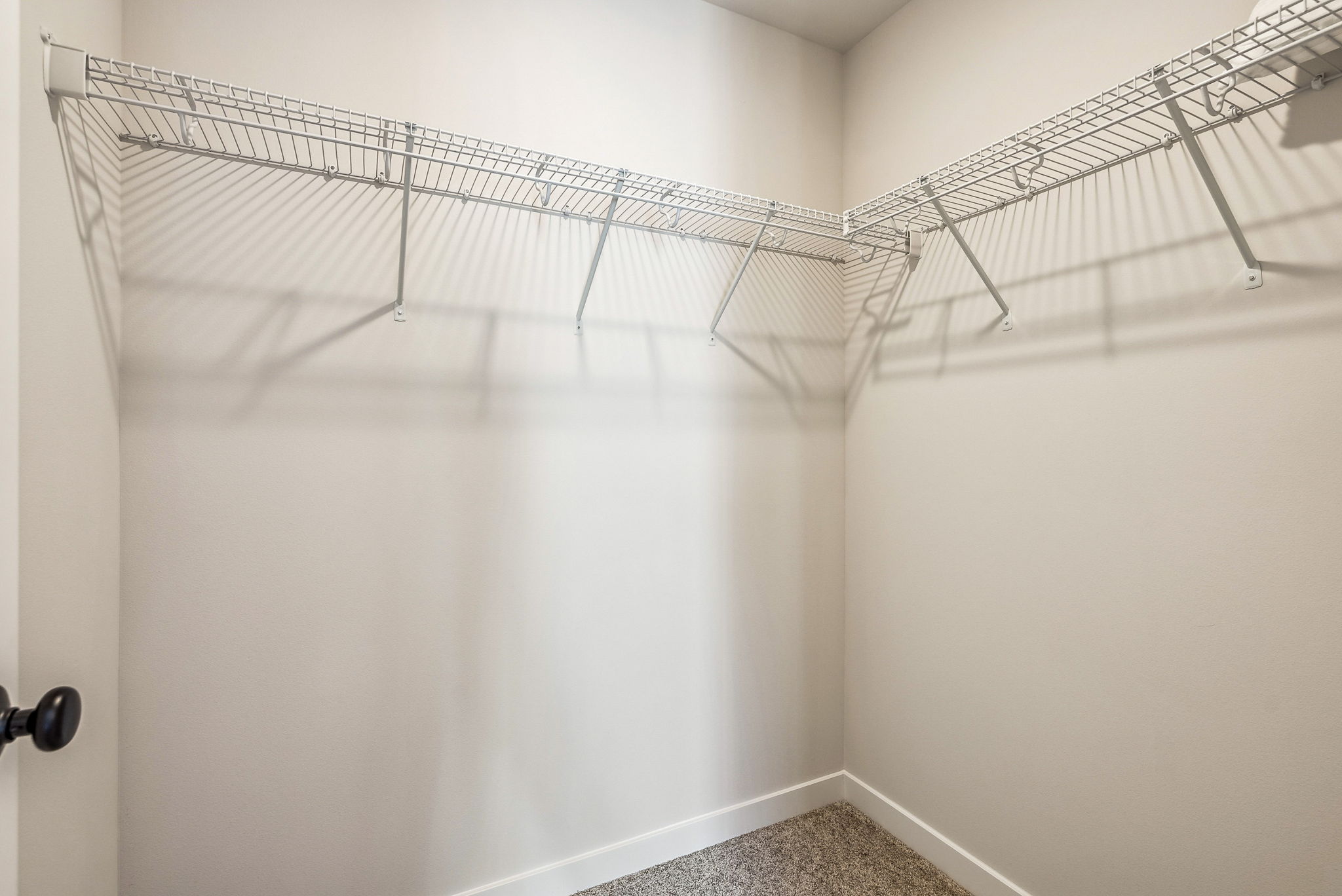 A shower with a metal bar.