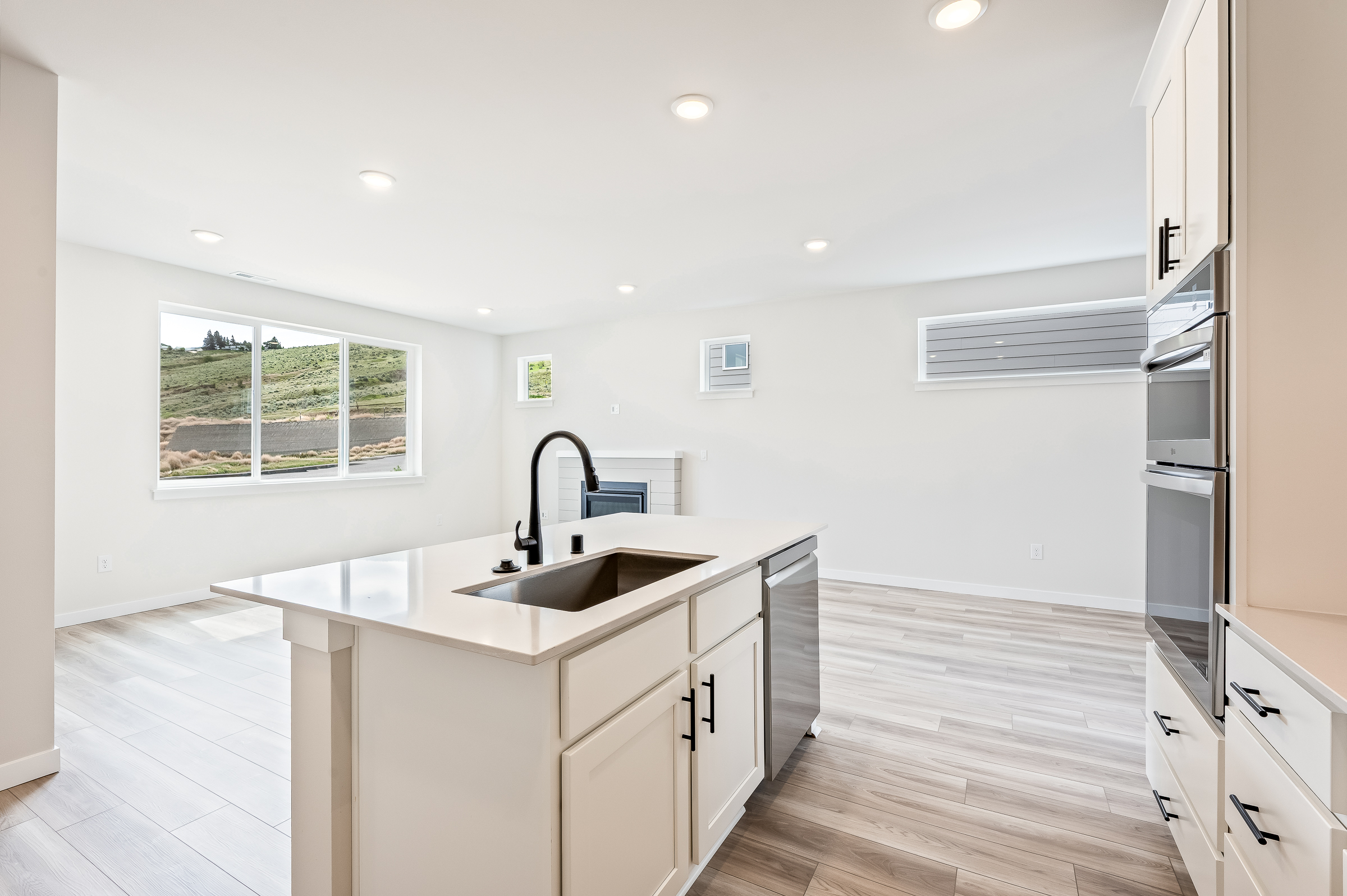 A kitchen with white cabinets.