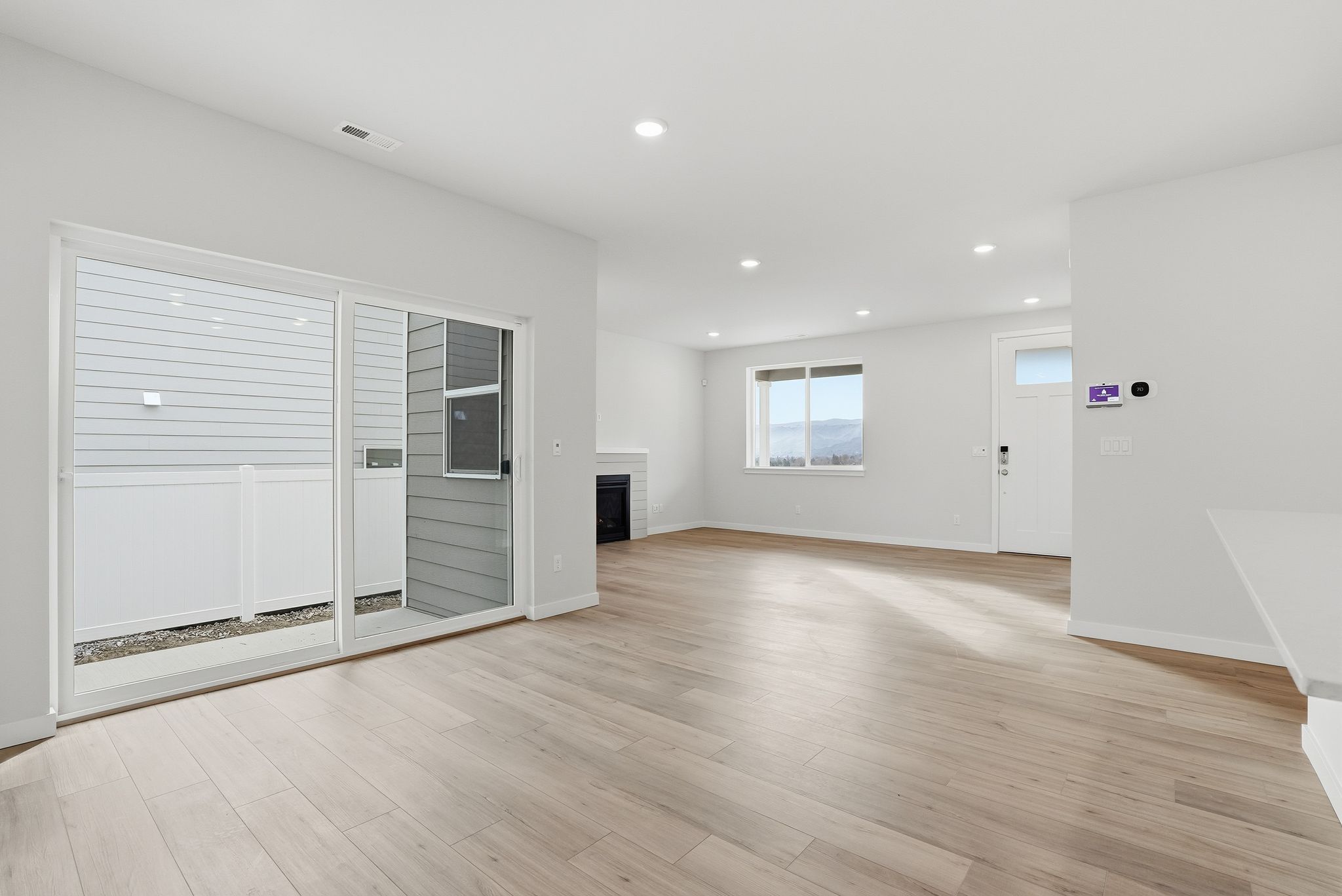 A room with white walls and a wood floor.