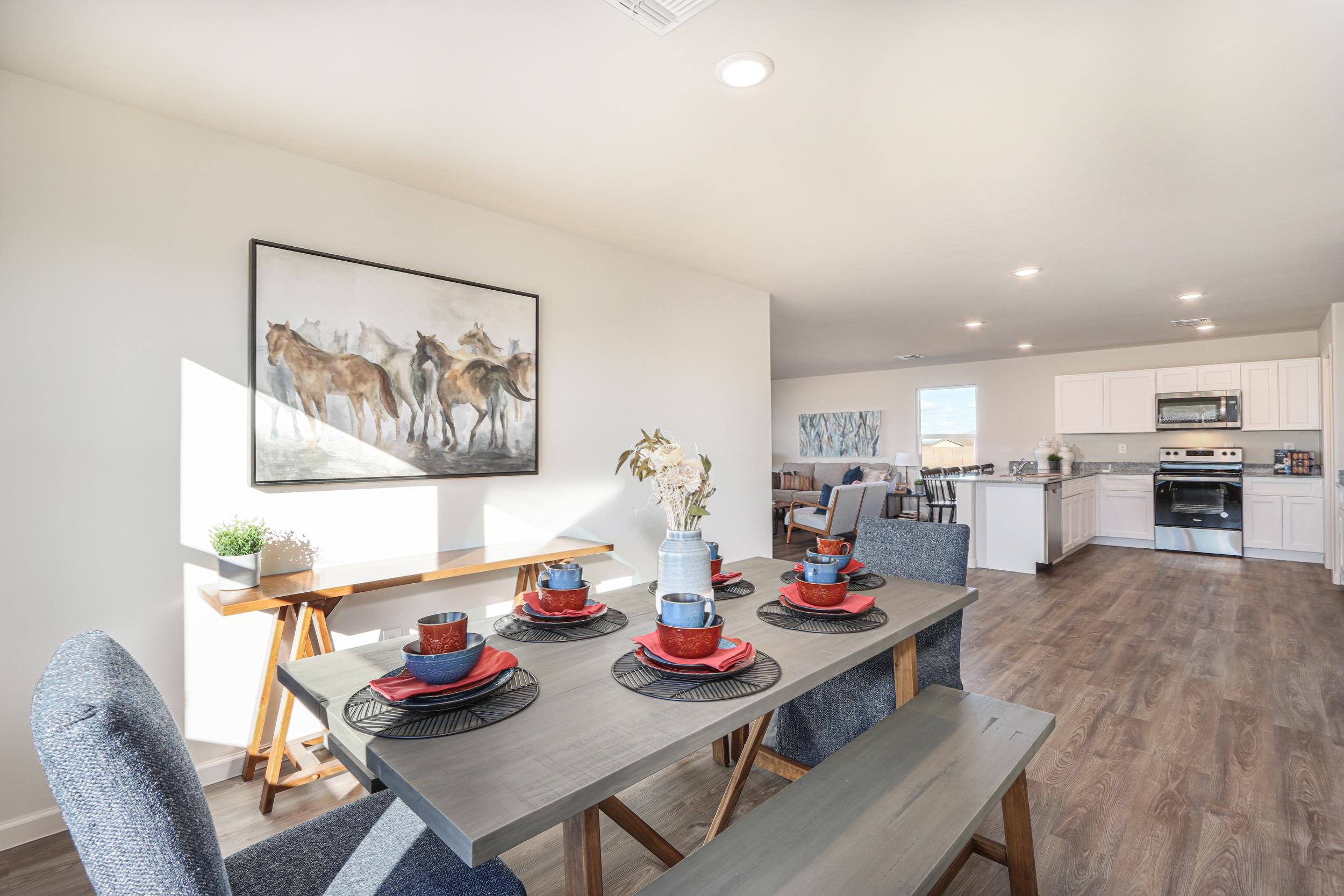 A dining room with a table and chairs.
