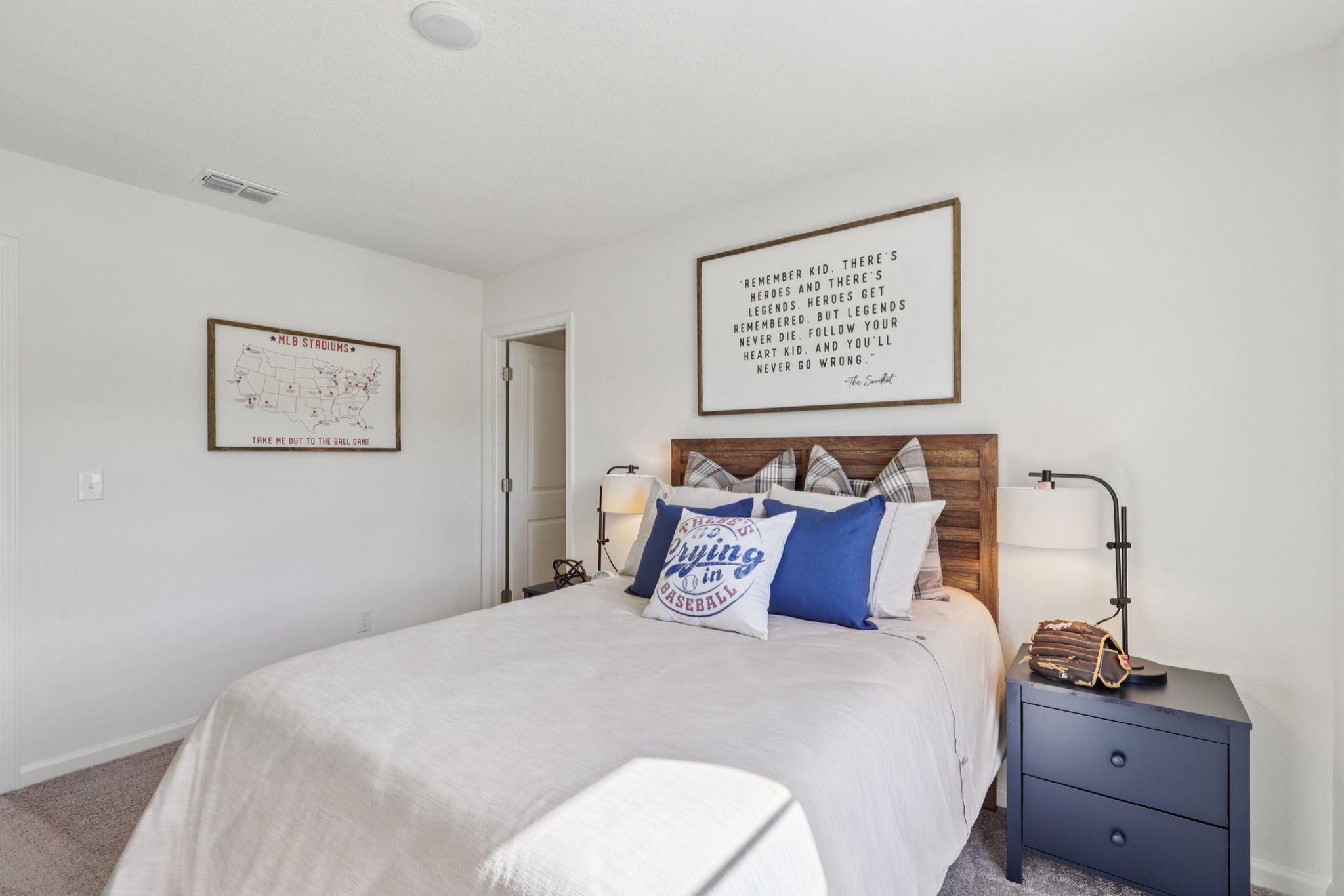 A bed with blue pillows.