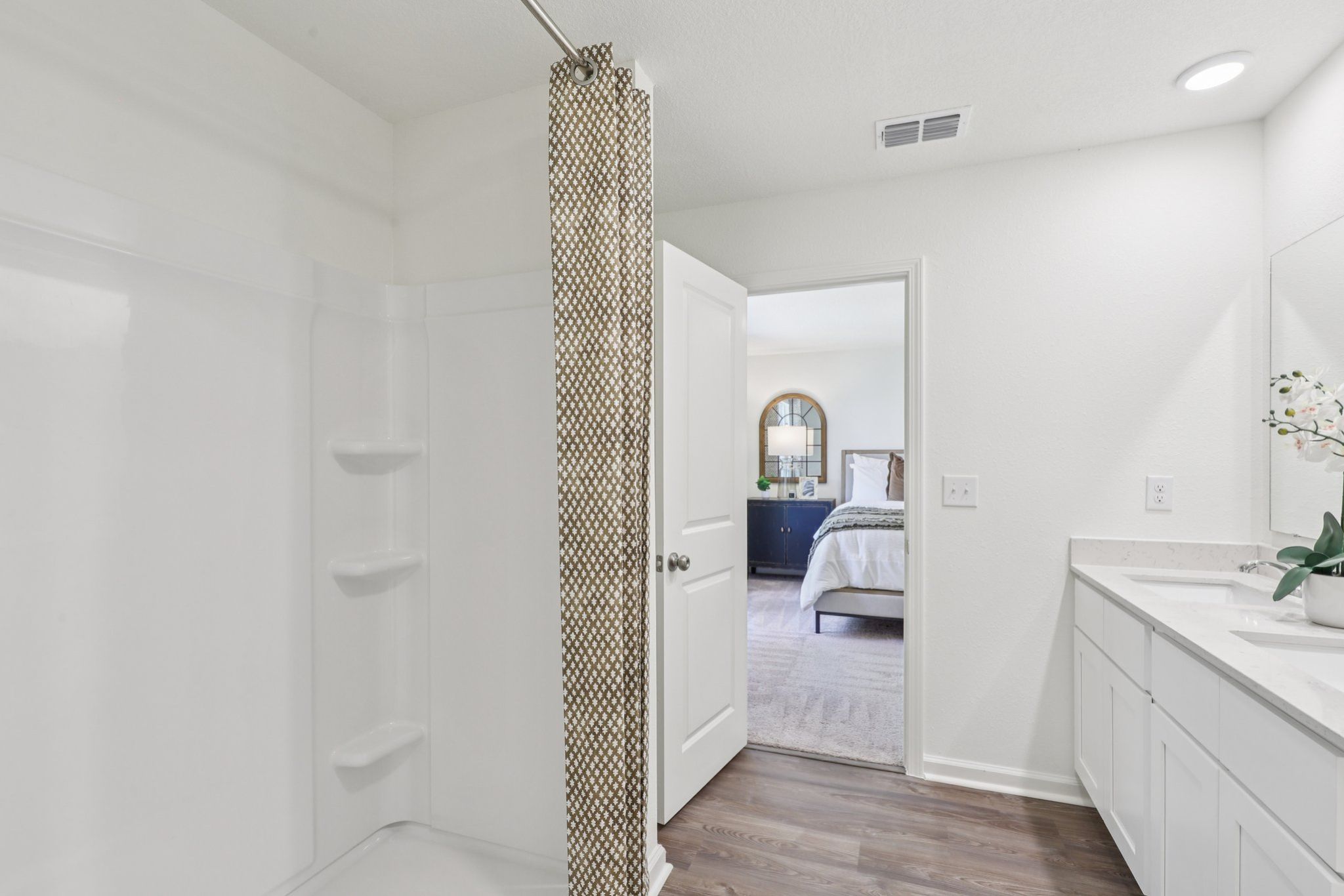 A bathroom with a shower and sink.