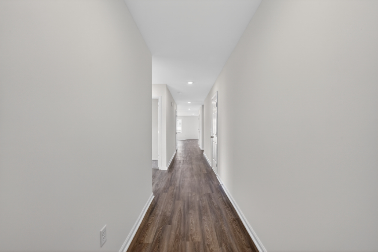 A long hallway with white walls.