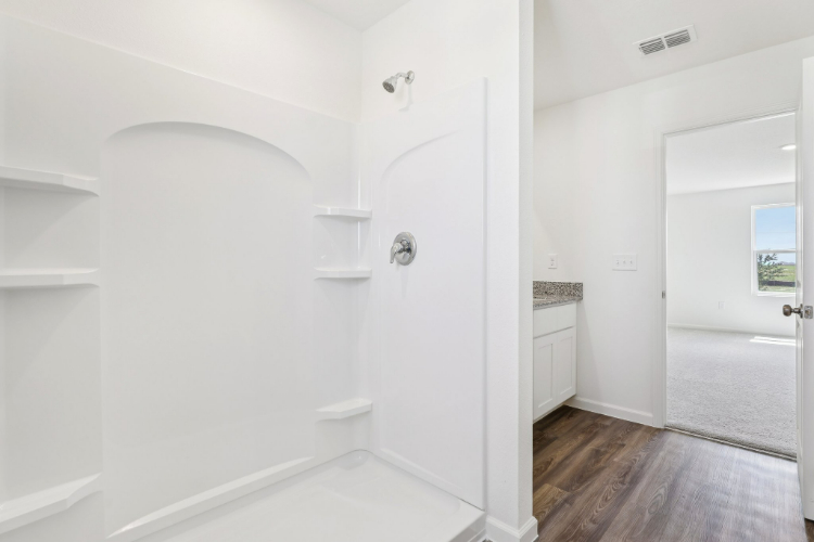 A bathroom with a shower unit.