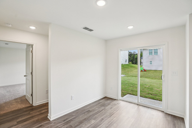 A room with a wood floor and a glass door.
