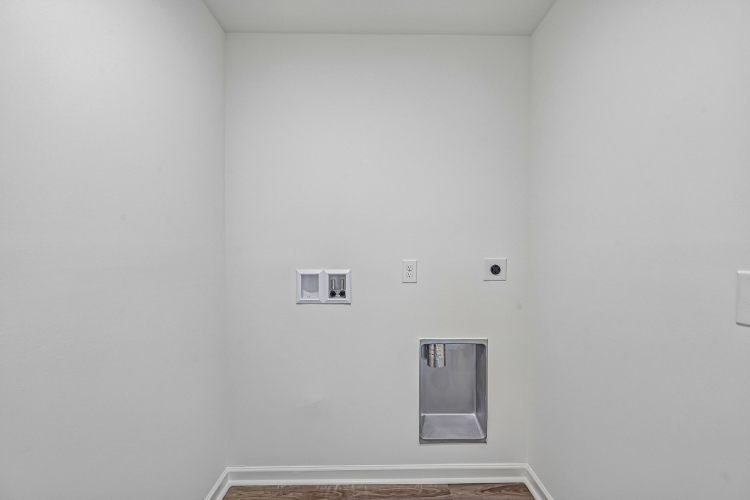 A white wall with a light switch.
