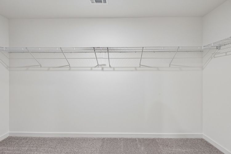 A white wall with a metal railing.