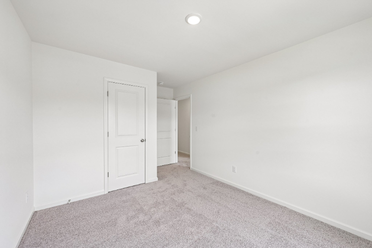 A hallway with white doors.