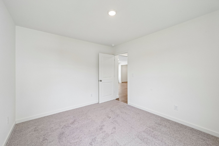 A hallway with white walls.