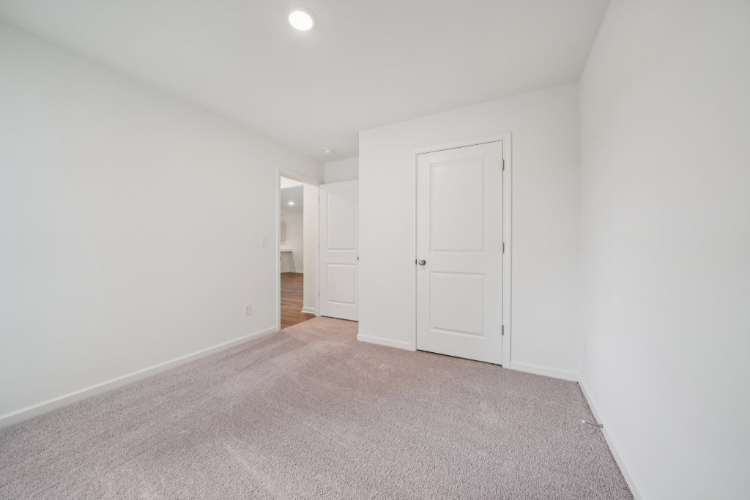A hallway with white doors.