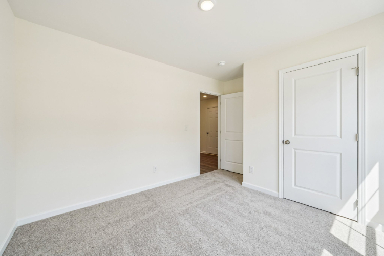 A hallway with white doors.
