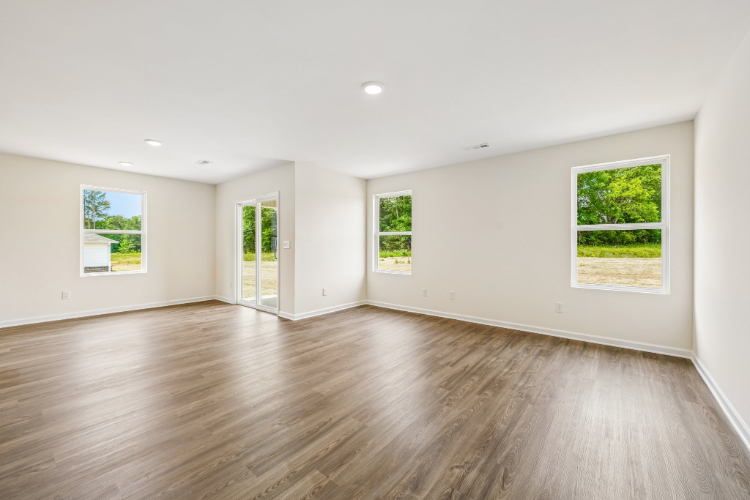 A room with a wood floor and a wood floor with a window.