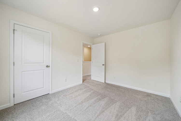 A hallway with white doors.