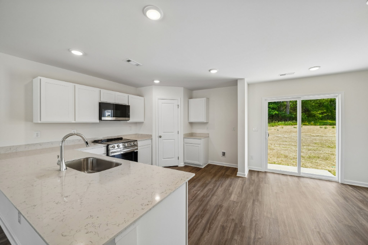 A kitchen with white cabinets.