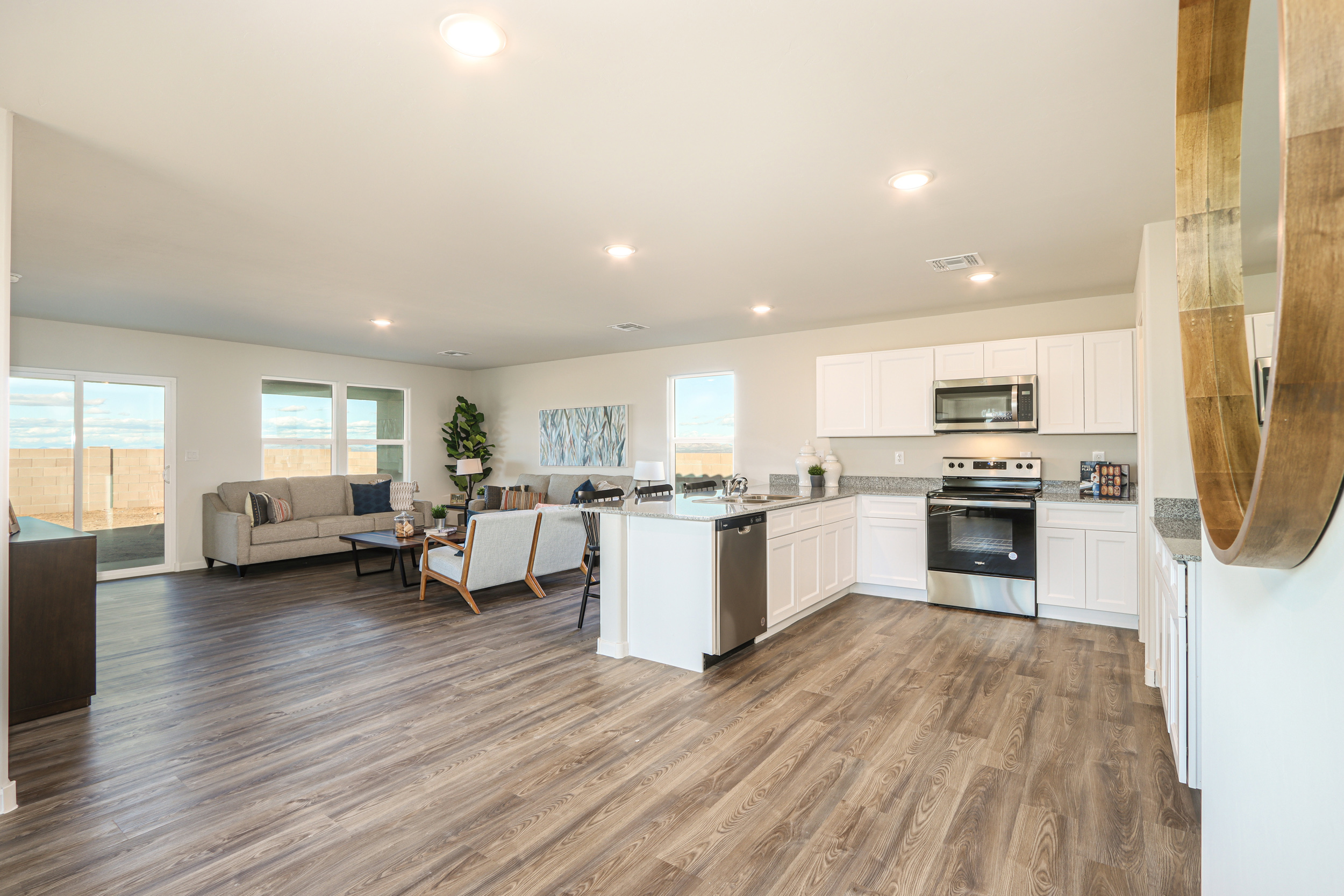 A large kitchen with a wood floor.