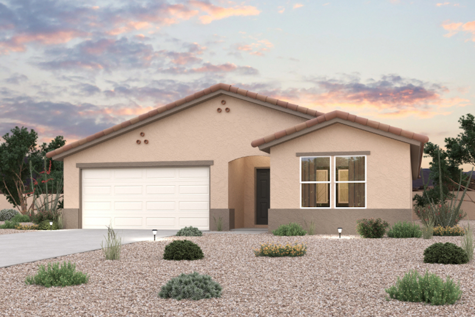 A house with a garage and bushes in front of it.
