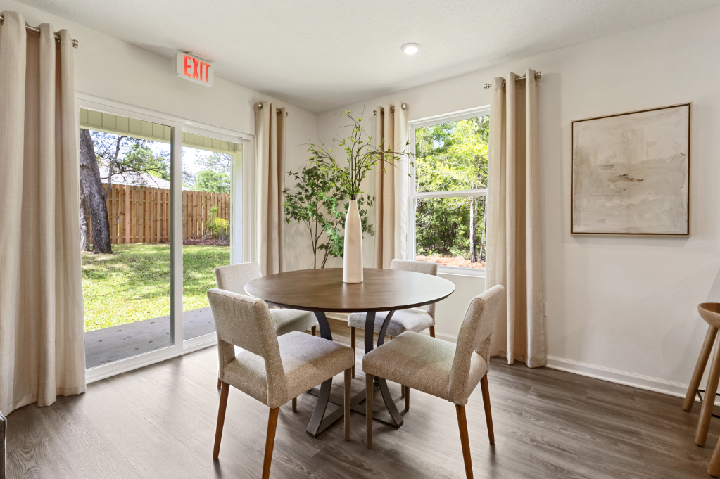 A dining room with a table and chairs.