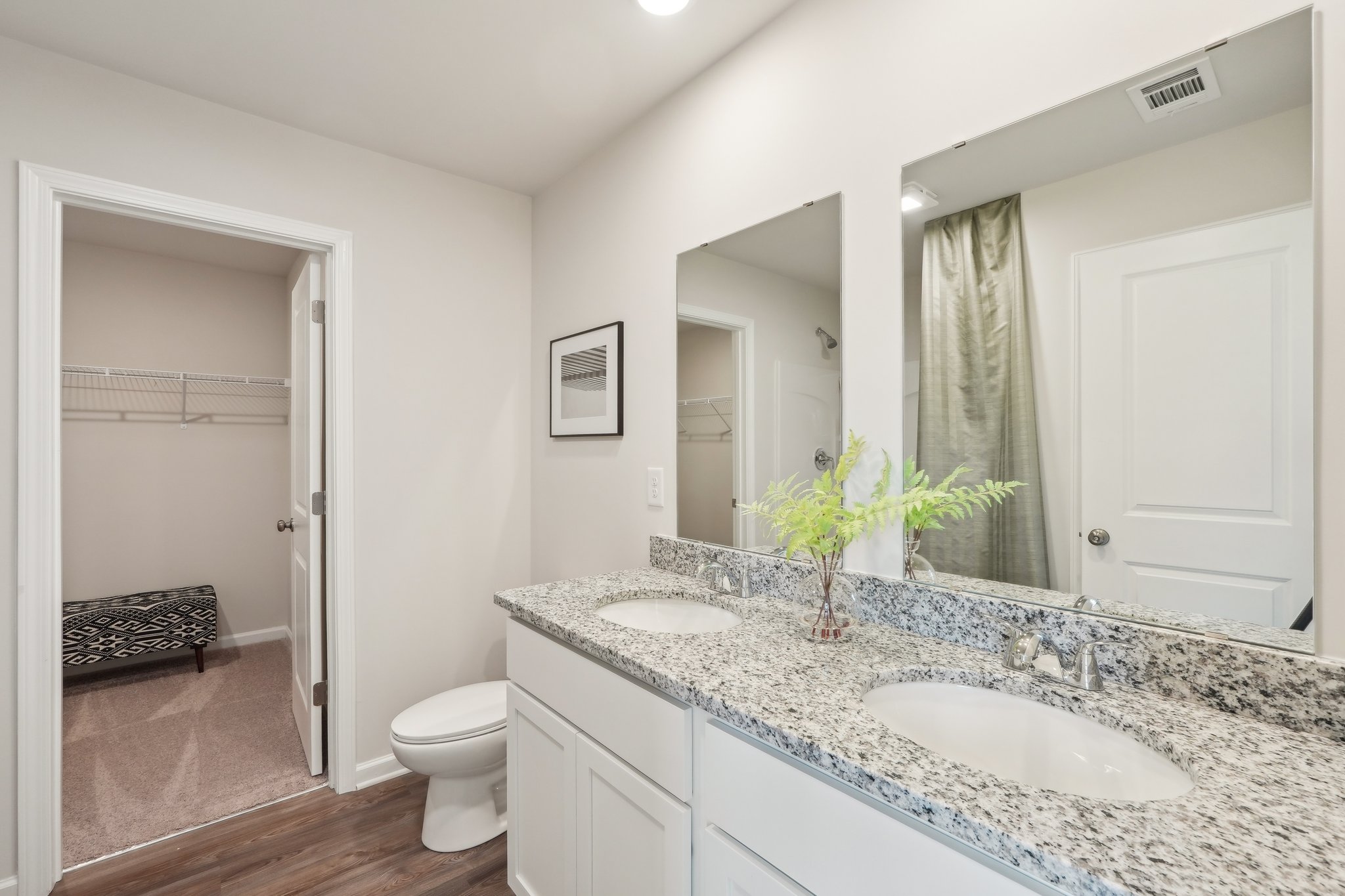 A bathroom with a large mirror.