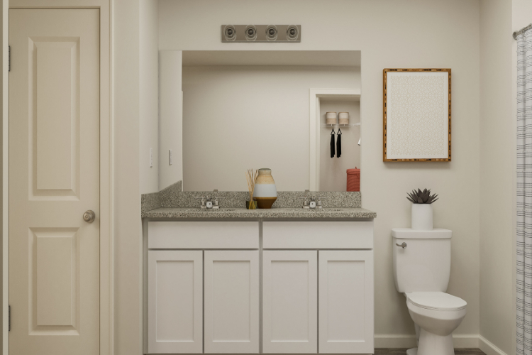 A bathroom with a sink toilet and mirror.