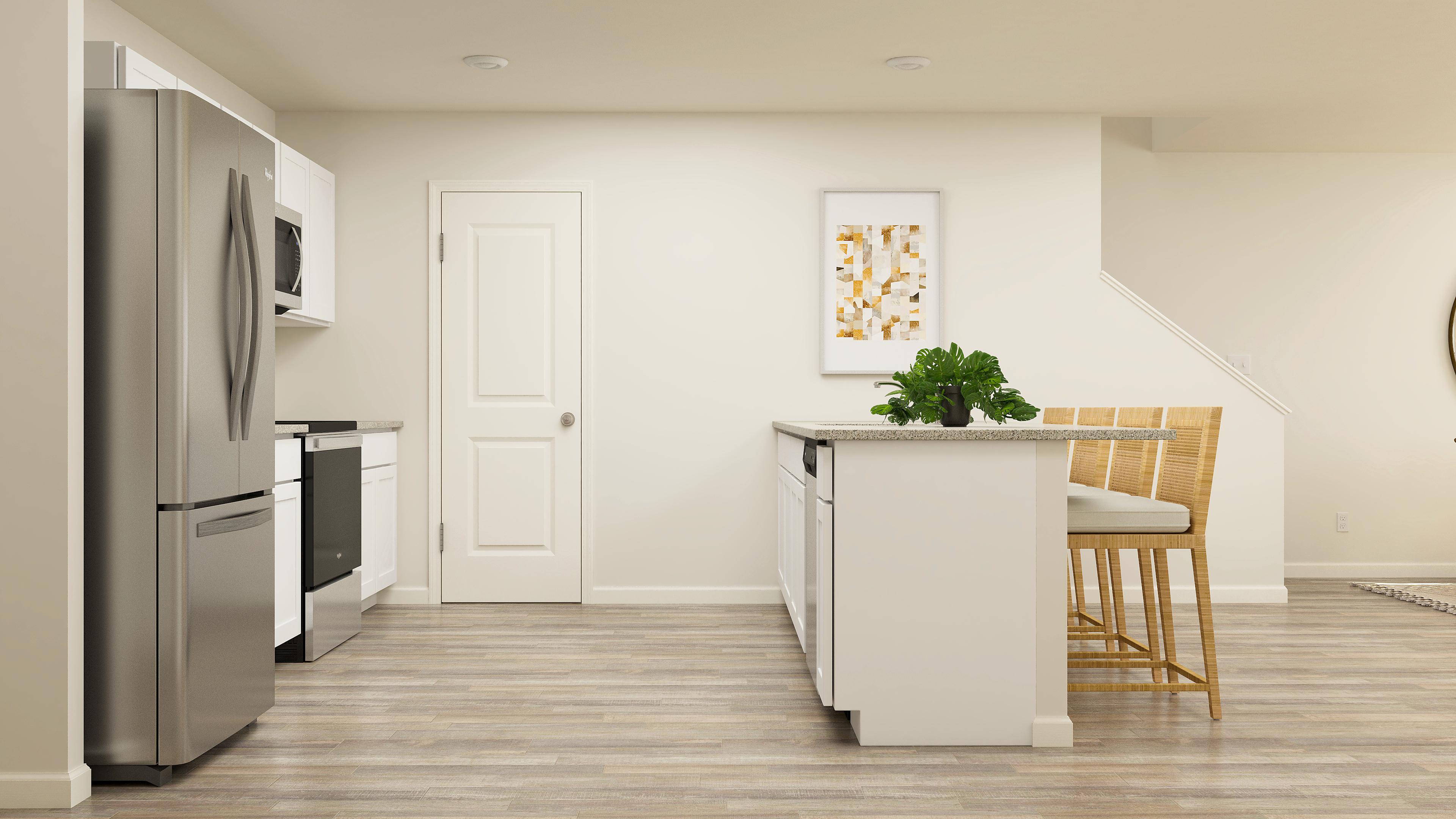 A kitchen with a table and chairs.