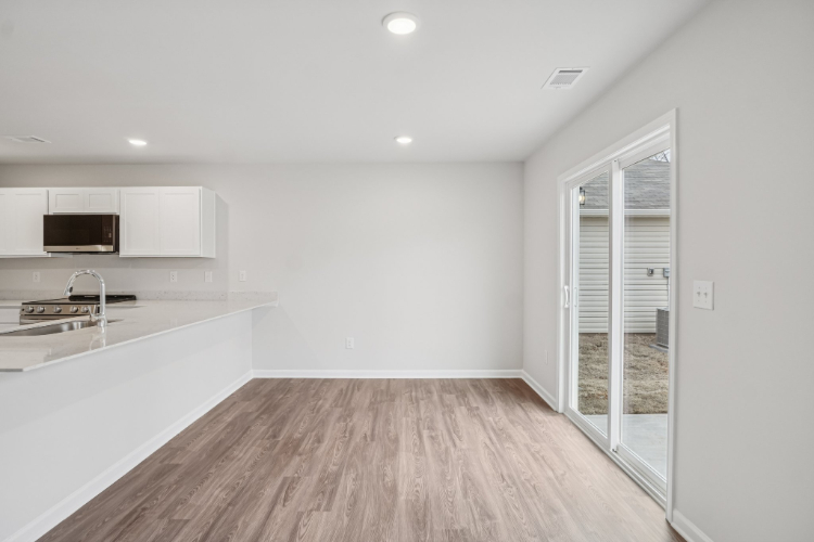 A kitchen with a wood floor.